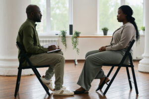 two people sitting in chairs across from each other