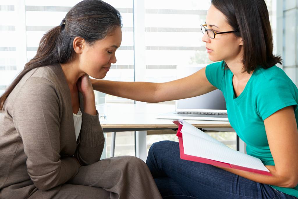 A woman being comforted in a counseling session
